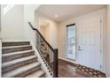 Bright entryway featuring hardwood floors, staircase, and direct access to the upper level at 147 Silver Rock Trl, Castle Rock, CO 80104
