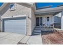 Inviting front porch with rocking chairs on a charming two-story home at 147 Silver Rock Trl, Castle Rock, CO 80104