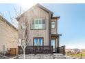 Modern two-story home with neutral siding, a small front porch, and a well-manicured lawn at 10524 Eby Cir, Lone Tree, CO 80124