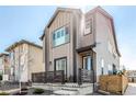 A two-story home showcasing its modern design, front yard, and well-maintained landscaping at 10524 Eby Cir, Lone Tree, CO 80124
