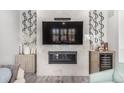 Stylish living room featuring a fireplace, mounted television, and elegant decor at 10524 Eby Cir, Lone Tree, CO 80124