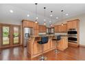Gourmet kitchen featuring stainless steel appliances, custom cabinetry, and granite countertops at 6293 Ponderosa Way, Parker, CO 80134