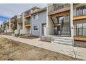 View of townhome complex with private exterior stairs, and a combination of siding finishes at 6009 Yarrow St # B, Arvada, CO 80004