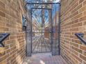 Secured entry gate with brick surround, providing privacy and security at 1011 N Pennsylvania St # H, Denver, CO 80203