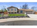 Charming two-story home with beautiful landscaping and an attached two-car garage at 1853 S Zeno Way, Aurora, CO 80017
