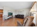 Comfortable living room with hardwood floors, neutral walls, and plenty of natural light at 1853 S Zeno Way, Aurora, CO 80017
