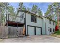Angled view of a two story home with two-car garage and balcony at 29762 Spruce Rd, Evergreen, CO 80439