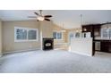Spacious living room featuring a fireplace and large windows offering lots of natural light at 29762 Spruce Rd, Evergreen, CO 80439