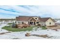 Large deck with hot tub and fire pit, backing to open space at 4075 Merada Ct, Franktown, CO 80116