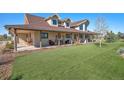 Charming home featuring a covered porch with ample seating, perfect for relaxing outdoors at 4075 Merada Ct, Franktown, CO 80116