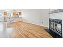 Bright living room featuring hardwood floors, fireplace, and seamless flow to the kitchen at 9621 W Chatfield Ave # F, Littleton, CO 80128