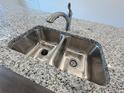 Close-up of a stainless steel sink with granite countertops on a kitchen island at 22023 E 38Th Pl, Aurora, CO 80019