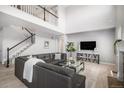 Spacious living room with high ceilings, a staircase, and an open floor plan at 5929 Echo Hollow St, Castle Rock, CO 80104