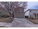Exterior shot showing a two-story house with a garage, and a long driveway at 4081 Odessa St, Denver, CO 80249