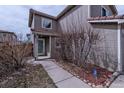 View of front entrance with covered porch, walkway, manicured shrubs, and an address sign at 4081 Odessa St, Denver, CO 80249