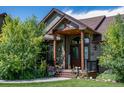 Inviting front entrance with covered porch and landscaping at 69649 E Briarwood Pl, Byers, CO 80103