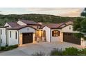 Front exterior of home with a brick-stone entryway and a three-car garage with stone accents at 8278 Raphael Ln, Littleton, CO 80125