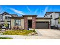 Charming single-story home featuring a brick facade, manicured lawn, and an attached two-car garage at 6469 Barnstead Dr, Castle Pines, CO 80108