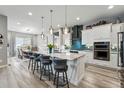 Spacious open-concept kitchen with granite countertops, oversized island, and stainless steel appliances at 6469 Barnstead Dr, Castle Pines, CO 80108