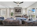 Bright living room with modern fireplace, large TV, and comfortable seating area at 6469 Barnstead Dr, Castle Pines, CO 80108
