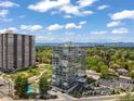 Beautiful aerial view of condo buildings with pool, tennis court, and lush green landscape at 3100 E Cherry Creek South Dr # 404, Denver, CO 80209