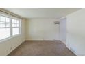 Spacious living room with ample natural light and neutral carpeting at 1540 S Knox Ct, Denver, CO 80219