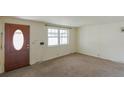 Inviting living room featuring a large window and neutral carpeting at 1540 S Knox Ct, Denver, CO 80219