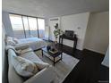 Bedroom featuring a full wall window with a view and hardwood floors at 1020 15Th St # 21M, Denver, CO 80202