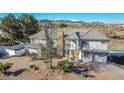 Beautiful home with large driveway, mature trees, and mountain views in a peaceful neighborhood at 14955 W 58Th Pl, Golden, CO 80403
