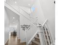Bright and airy staircase with white railing and walls, leading to the upper levels at 6591 N Ceylon St, Denver, CO 80249