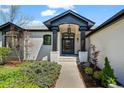 Inviting front entrance with a covered porch, showcasing the house number and well-maintained landscaping at 5302 Pinehurst Dr, Boulder, CO 80301