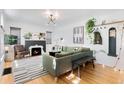 Bright living room with hardwood floors, stylish decor, and a modern fireplace at 2734 King St, Denver, CO 80211