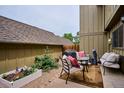 Backyard patio featuring outdoor seating, a grill, and a garden planter with flowers at 8170 E Phillips Cir, Centennial, CO 80112