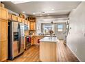Well-lit kitchen features stainless steel appliances and an island at 7848 W 54Th Ave, Arvada, CO 80002