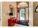 Inviting foyer with a bright red door and classic console table at 3644 Rosewalk Cir, Highlands Ranch, CO 80129