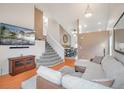 Inviting living room with high ceilings, a modern sectional sofa, and a view of the staircase at 10405 Dresden St, Firestone, CO 80504