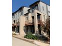Contemporary townhomes with brick accents and balconies, showcasing modern architecture and design at 10150 Belvedere Loop, Lone Tree, CO 80124
