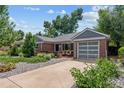 Charming single-story brick home with a two-car garage and well-maintained front yard at 2875 Leyden St, Denver, CO 80207