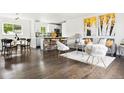 Open-concept living room with hardwood floors, modern decor, and seamless flow to the kitchen at 2875 Leyden St, Denver, CO 80207