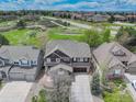 Aerial view of a brown home in a peaceful neighborhood with nearby green space at 12451 Turquoise Terrace Pl, Castle Pines, CO 80108