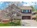 Charming two-story home featuring a two car garage, mature landscaping, and beautiful architecture at 12451 Turquoise Terrace Pl, Castle Pines, CO 80108
