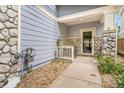 Charming front porch area with stone accents and space for outdoor seating at 6110 Raleigh Cir, Castle Rock, CO 80104
