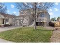 Inviting two-story home with a well-kept lawn, and a covered front porch in a suburban neighborhood at 20466 Willowbend Ln, Parker, CO 80138