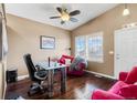 Bright office space with hardwood floors, unique desk, and a comfortable seating area with large window at 20466 Willowbend Ln, Parker, CO 80138