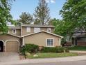Home featuring well-maintained landscaping, an attached garage, and a classic design, perfect for suburban living at 12599 Elm St, Thornton, CO 80241