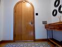 Entryway with a wooden arched door, decorative floor tiles, and side table at 1315 Grape St, Denver, CO 80220
