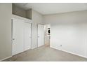 Neutral bedroom with vaulted ceilings features a closet and door to the utility room at 1978 Newland Ct, Lakewood, CO 80214