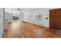 Spacious living room with hardwood floors, large windows and a sliding door at 1573 S Dexter Way, Denver, CO 80222