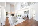 Bright living room with hardwood floors, a fireplace, wet bar and modern furniture at 3957 S Peach Way, Denver, CO 80237
