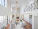 Sun-filled living room with fireplace, high ceilings and a second-story balcony at 3957 S Peach Way, Denver, CO 80237